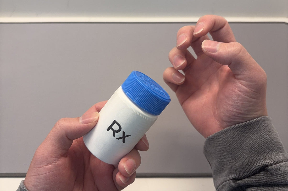 Person struggling to open a childproof pill bottle with arthritic hands