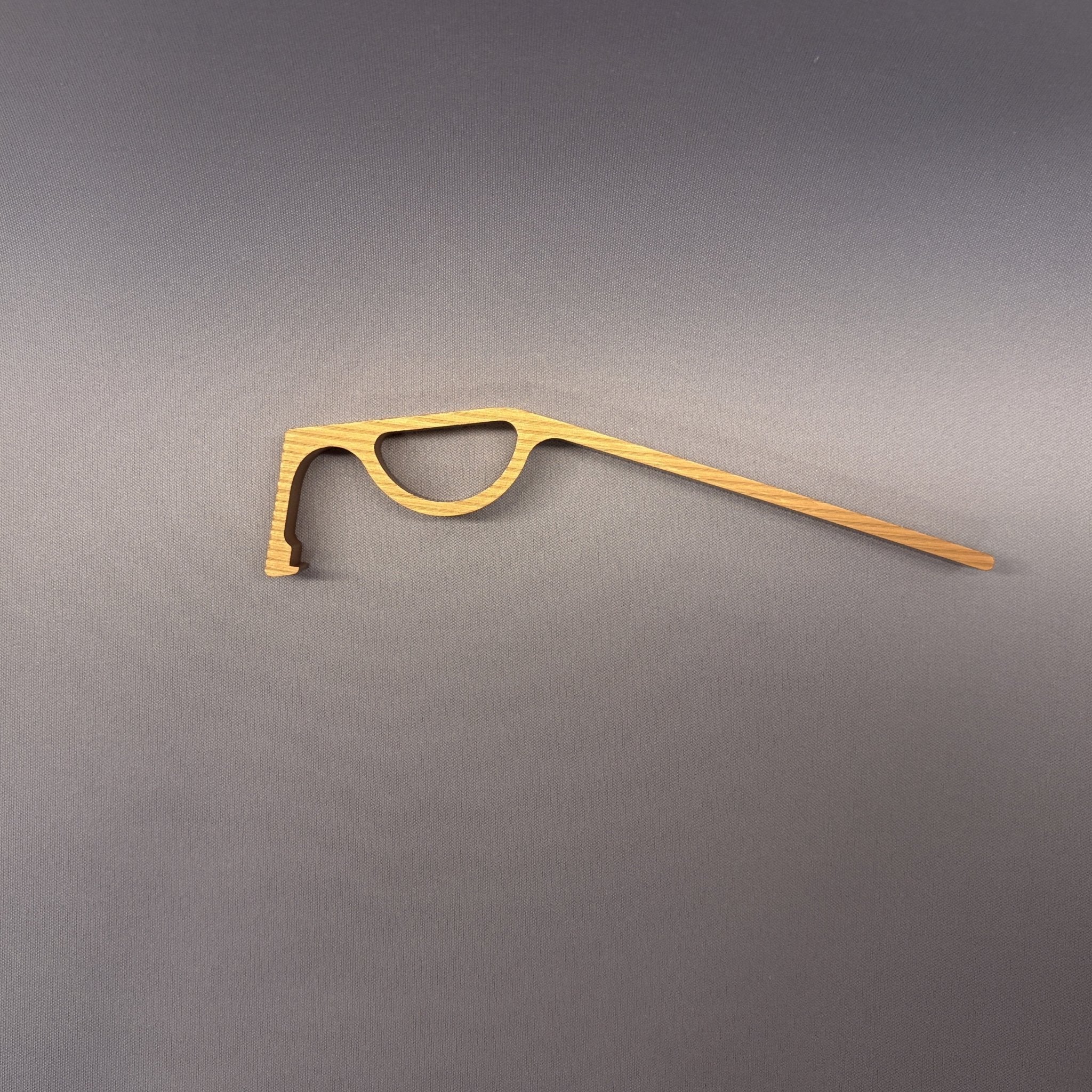 DCAPer medicine bottle opener in gold finish, flat lay